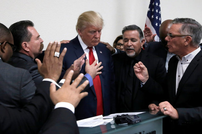 President-elect Donald Trump prays with pastors during a campaign visit to the International Church of Las Vegas and the International Christian Academy in Las Vegas, Nevada, October 5, 2016.