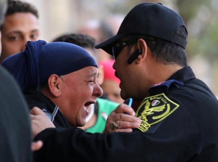 A relative of one of the blast victims screams at a police officer in front of St. Mark's Coptic Orthodox Cathedral after an explosion inside the cathedral in Cairo, Egypt December 11, 2016.