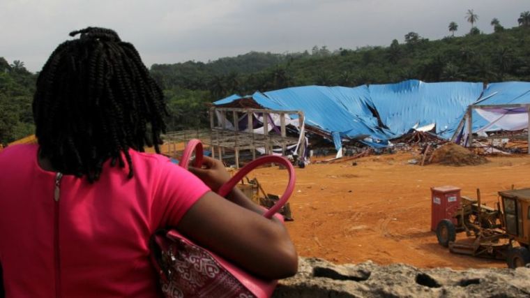 A woman seeking her loved ones is seen at the venue of the collapsed church building in Uyo, Nigeria December 11, 2016.