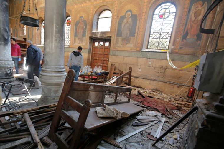 Egyptian security officials and investigators inspect the scene following a bombing inside Cairo's Coptic cathedral in Egypt, December 11, 2016.