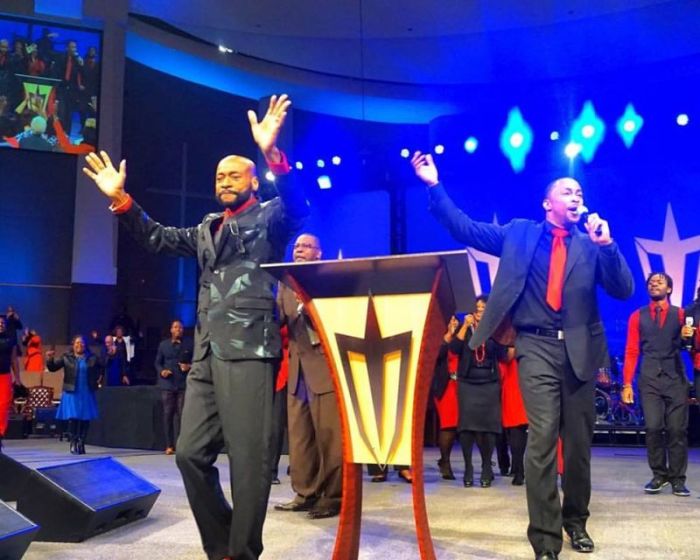 Eddie Long, 63 (L), senior pastor of New Birth Missionary Baptist Church in Lithonia, Georgia, returns to his congregation after another brief absence on December 11, 2016.