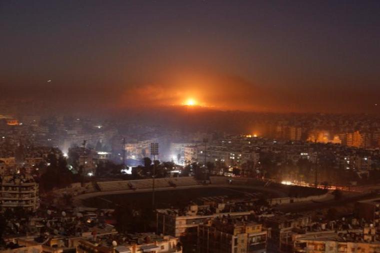 Smoke and flames rise after air strikes on rebel-controlled besieged area of Aleppo, as seen from a government-held side, in Syria, December 11, 2016.