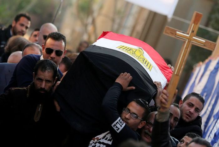 Relatives of Nabiel Habieb, a Christian man who was killed in the bombing of Cairo's main Coptic cathedral, carry his body to bury him at the Mokattam Cemetery in Cairo, Egypt, December 12, 2016.