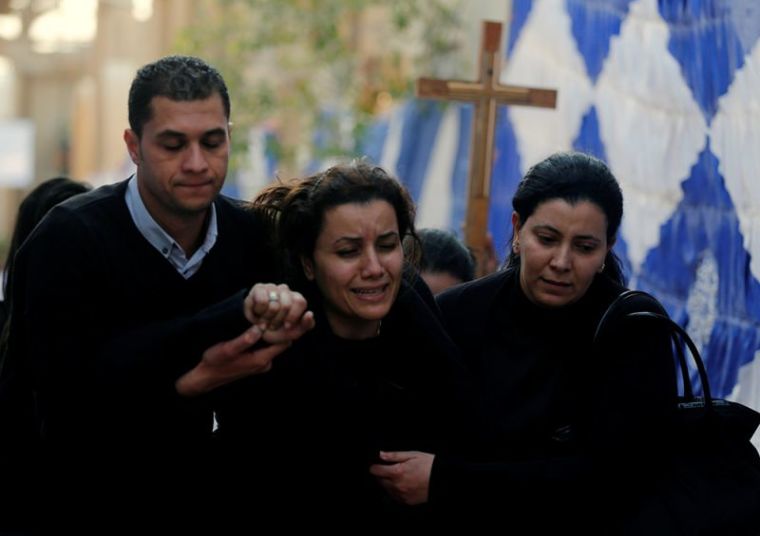 Egyptian Christians react during the funeral of victims killed in the bombing at Cairo's Coptic cathedral, at the Mokattam Cemetery in Cairo, Egypt, December 12, 2016.