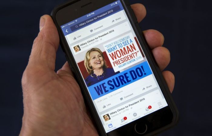 A mobile phone shows a Facebook page promoting Hillary Clinton for president in 2016, in this photo illustration taken April 13, 2015. By one estimate U.S. online political advertising could quadruple to nearly billion in the 2016 election, creating huge opportunities for digital strategy firms eager to capitalize on a shift from traditional mediums like television.