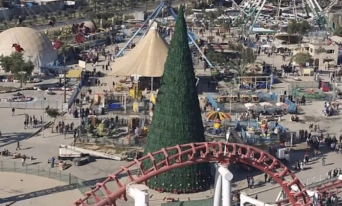 A giant 85-foot Christmas tree erected at the al-Zawraa amusement park in Baghdad in December 2016.