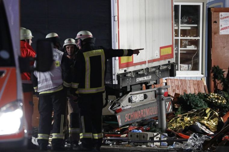 Firefighter stand beside a truck at a Christmas market in Berlin, Germany, December 19, 2016, after the truck ploughed into the crowded Christmas market in the German capital.