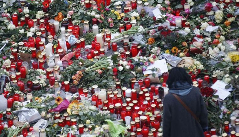 Flowers and candles are placed near the Christmas market in Berlin, Germany, December 21, 2016, after a truck ploughed through a crowd at the Christmas market on Monday night.