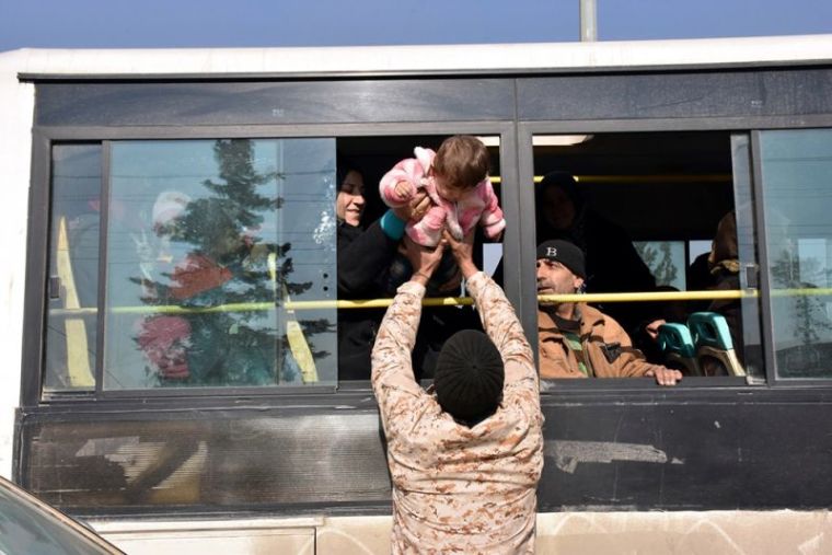 People who fled the Shi'ite Muslim villages of al-Foua and Kefraya arrive in government controlled Jibreen area in Aleppo, Syria, in this handout picture provided by SANA on December 19, 2016.