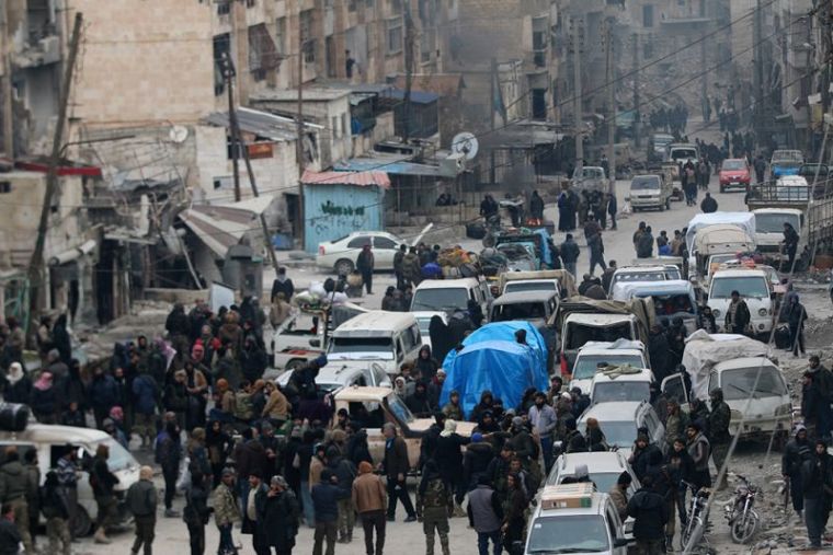 Rebel fighters and civilians wait to be evacuated from a rebel-held sector of eastern Aleppo, Syria December 18, 2016.