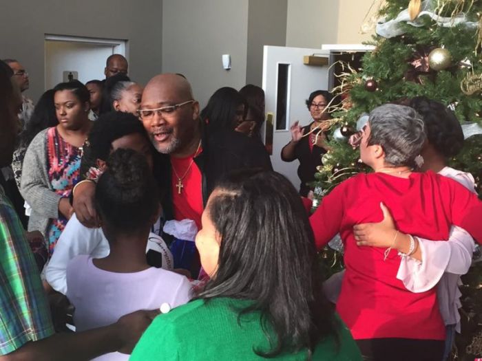 Senior Pastor of Higher Living Christian Church in McDonough, Georgia, Andre Landers, greets members of his new iThrive Christian Church on Christmas Day.