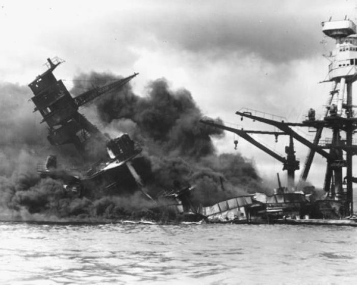 The battleship USS ARIZONA sinks after being hit by a Japanese air attack on Pearl Harbor, Hawaii, Dec. 7, 1941.