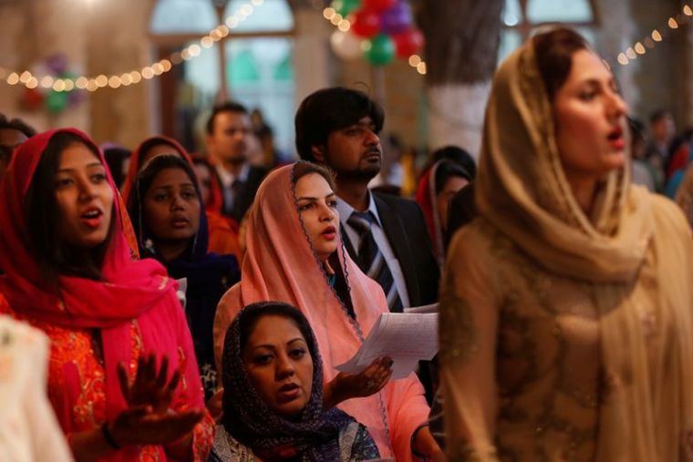 People pray as they gather for a ceremony on Christmas eve at Central Brooks Memorial Church in Karachi, Pakistan, December 24, 2016.