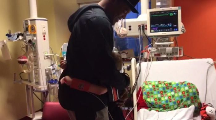 10-year-old Austin Deckard embracing Cam Newton after the NFL star made a surprise visit to his young fan's hospital room.