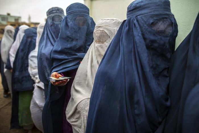 Afghan women stand in line while waiting to vote at a polling station in Mazar-i-sharif on April 5, 2014. Voting was peaceful during the first few hours of Afghanistan's presidential election on Saturday, with only isolated attacks on polling stations as the country embarked on the first democratic transfer of power since the fall of a Taliban regime in 2001.