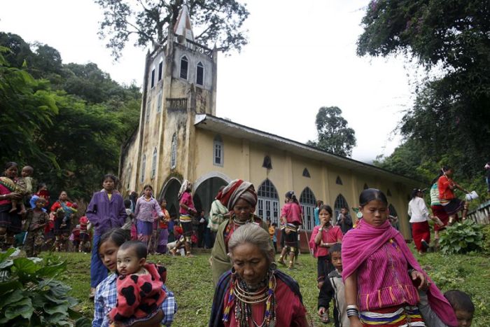 Ethnic Kayaw people walk out after a mass at the catholic church at Htaykho village in the Kayah state, Myanmar, September 13, 2015.