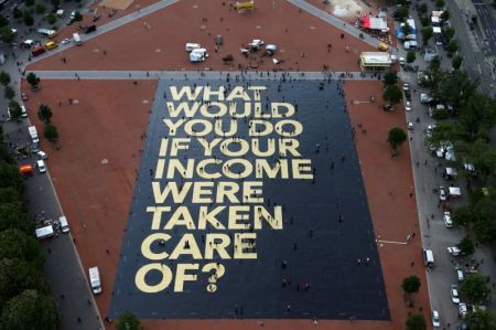 A large poster in a square in Geneva, Switzerland, promoting the idea of a universal basic income.