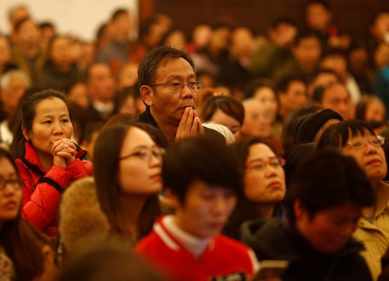 People attend a Christmas Eve Mass at a Catholic church in Shanghai, China, December 24, 2016.