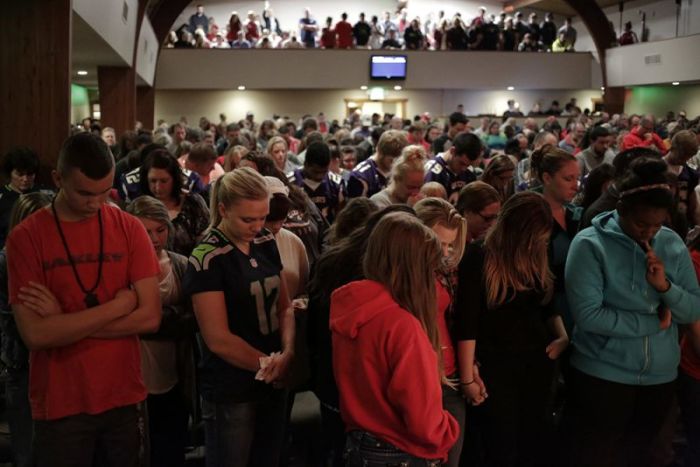People pray during a community vigil at the Grove Church following a shooting at Marysville-Pilchuck High School in Marysville, Washington October 24, 2014. .