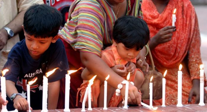 Christian children light candles in memory of those who died in a bomb attack on a church five years ago in Baniarchar 200km south west of the capital, Dhaka, June 3,2006.