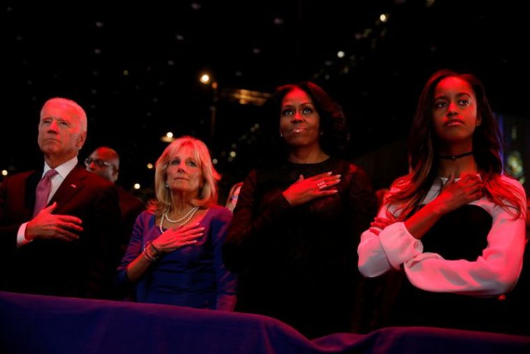 U.S. Vice President Joe Biden (L-R), his wife Jill Biden, first lady Michelle Obama and her daughter Malia Obama stand for the national anthem before President Barack Obama delivers his farewell address in Chicago, Illinois, January 10, 2017.
