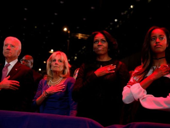 US Vice President Joe Biden (L-R), his wife Jill Biden, first lady Michelle Obama and her daughter Malia Obama stand for the national anthem before President Barack Obama delivers his farewell address in Chicago, Illinois, US January 10, 2017.