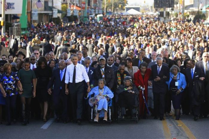 President Obama, at left in white shirt, joins in a march across the Edmund Pettus Bridge in Selma, Alabama, on March 7, 2015. Marching with him are, from left, Obama's mother-in-law Marian Robinson, daughter Sasha, first lady Michelle and Rep.