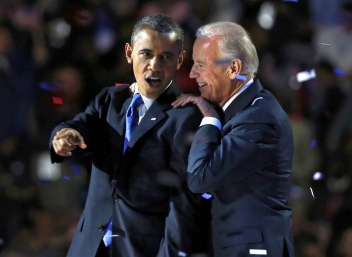 President Obama huddles with Vice President Joe Biden after his election night victory speech in Chicago on Nov. 6, 2012.