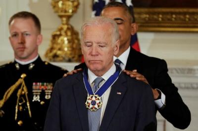 U.S. President Barack Obama presents the Presidential Medal of Freedom to Vice President Joe Biden in the State Dining Room of the White House in Washington, U.S., January 12, 2017.