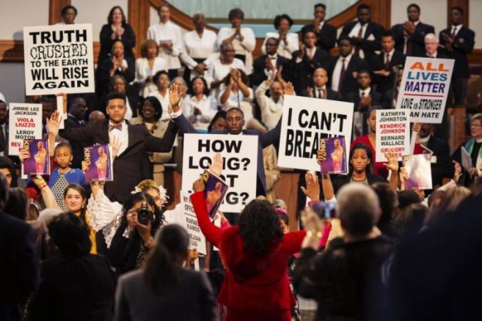 High school and college students hold civil rights signs during The King Center's 47th Annual Martin Luther King Jr. Commemorative Service in Atlanta January 19, 2015.