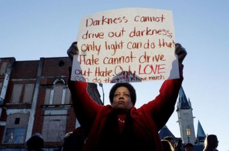 Barbara Carter of Tuscaloosa holds a sign as she waits on a commemorative march by the cast of the movie "Selma" in Selma, Alabama January 18, 2015.