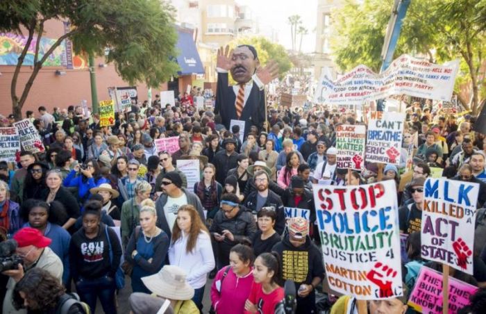 More than a thousand black rights demonstrators gather to mark Martin Luther King Jr. Day in Oakland, California January 19, 2015.