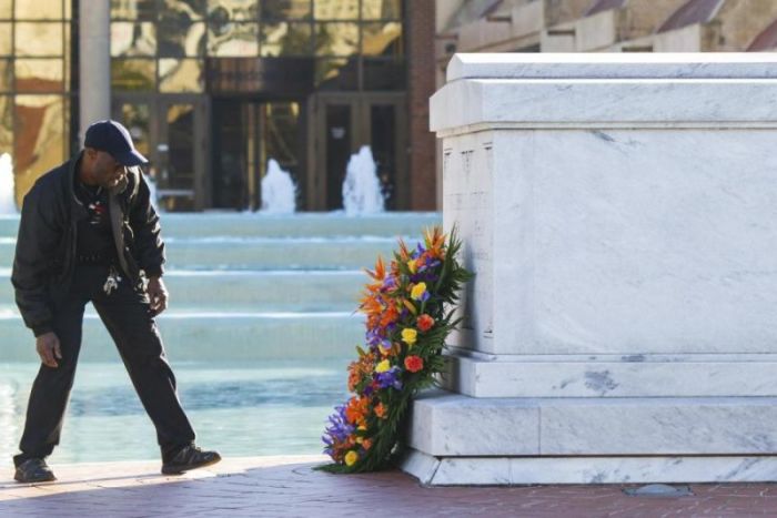 King Center employee Jade Dowd places a wreath at the crypt of Dr. Martin Luther King Jr. and his wife Coretta Scott King prior to The King Center's 47th Annual Martin Luther King Jr. Commemorative Service in Atlanta January 19, 2015.