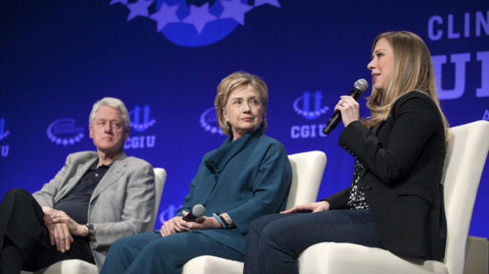 Former President Bill Clinton (L) and former Secretary of State Hillary Clinton (C) watch their daughter and Vice Chair of the Clinton Foundation Chelsea Clinton.