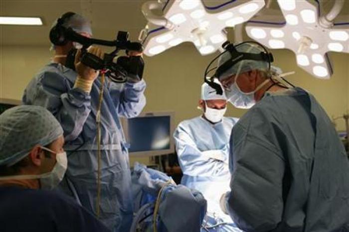 File: A heart surgeon and his team performs a complex mitral valve reconstruction at Papworth Hospital in Cambridge July 5, 2007.