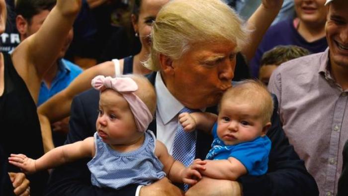 Republican presidential nominee Donald Trump kisses a baby at a campaign rally in Colorado Springs, Colorado, U.S., July 29, 2016.