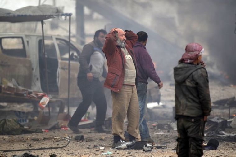 A man reacts near damaged vehicles after a car bomb explosion in Jub al Barazi east of the northern Syrian town of al-Bab, Syria, January 15, 2017.