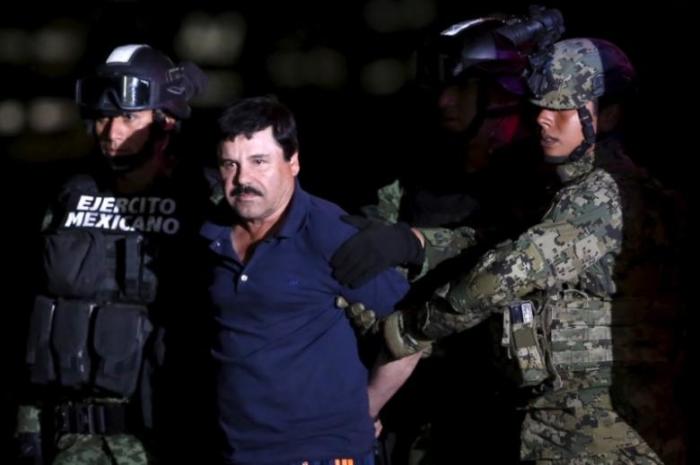 File Photo: Joaquin 'El Chapo' Guzman is escorted by soldiers during a presentation at the hangar belonging to the office of the Attorney General in Mexico City, Mexico January 8, 2016.