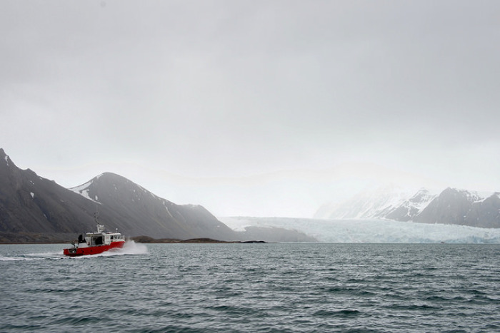 The research vessel 'Teisten,' carrying U.S. Secretary of State John Kerry and Norwegian Foreign Minister Borge Brende, cuts through the Kongsfjorden in Ny-Alesund, Norway, the northernmost civilian settlement in the world, en route to the Blomstrand Glacier so the two leaders could see the effects of global warming on the Arctic environment on June 16, 2016.