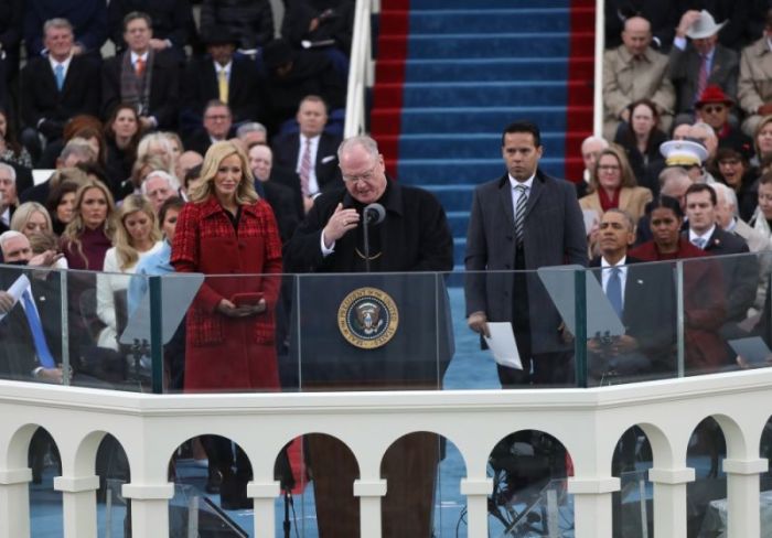 Timothy Michael Cardinal Dolan (M) delivers the invocation before U.S. President-elect Donald Trump is sworn in by Supreme Court Chief Justice John Roberts during inauguration ceremonies in Washington, U.S., January 20, 2017. Dolan is flanked by Samuel Rodriguez (R) and Paula White (L).