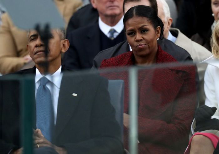 Outgoing U.S. first lady Michelle Obama listens with outgoing President Barack Obama (L) to incoming President Donald Trump speak during inauguration ceremonies at the U.S. Capitol in Washington, U.S., January 20, 2017.