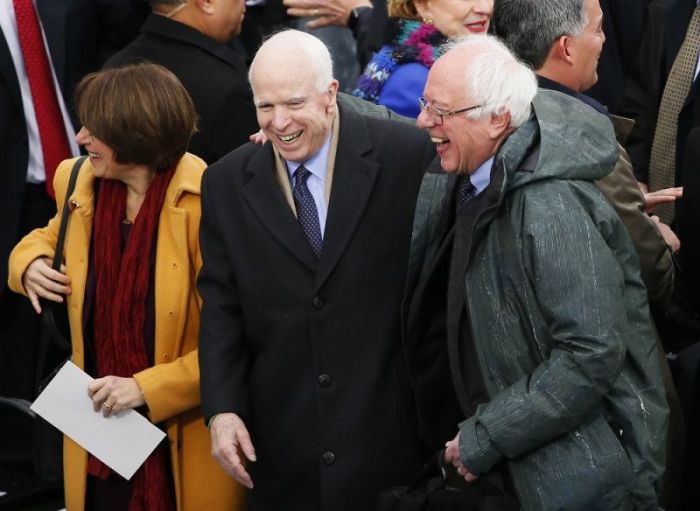 Republican Senator John McCain and Democratic Senator Bernie Sanders share a laugh as they arrive at the inauguration ceremonies swearing in Donald Trump as the 45th president of the United States on the West front of the U.S. Capitol in Washington, U.S., January 20, 2017.