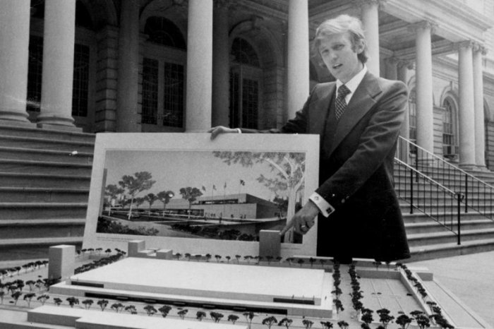 Donald Trump shows a model and picture of a Trump Organization real estate project in New York in the 1970s.