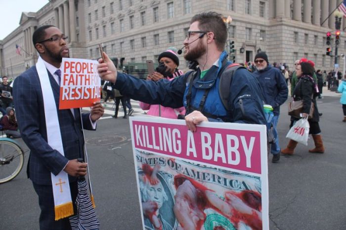 Ordained minister Darrell Hamilton from North Carolina engages in a conversation with a pro-life Christian street evangelist from Springfield, Virginia during the Women's March on Washington on Jan. 21, 2017.