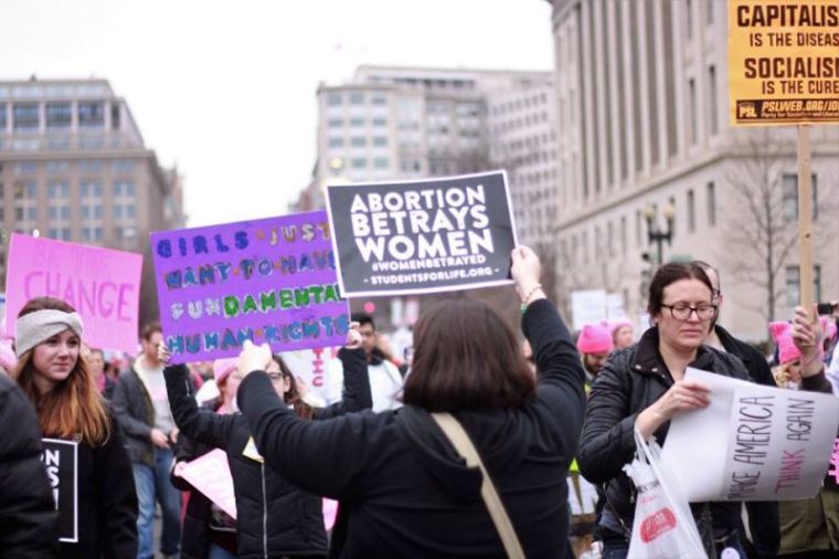 Students for Life of America President Kristan Hawkins engages participants in the Women's March on Washington on January 21, 2017.