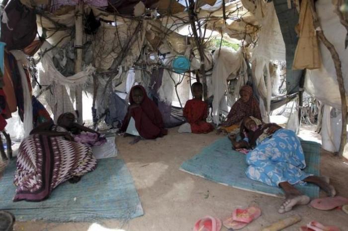 A Somali refugee family is pictured inside their makeshift shelter at the Ifo camp in Dadaab near the Kenya-Somalia border, May 8, 2015.