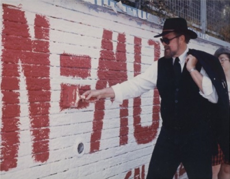 Joseph Scheidler paints a pro-life sign on an official graffiti wall in Cape Town, South Africa in 1995.
