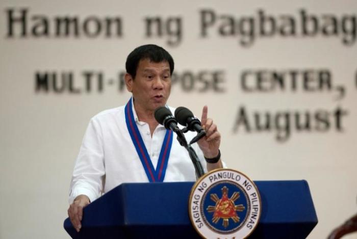 Philippine President Rodrigo Duterte gestures while delivering a speech during the 115th Police Service Anniversary at the Philippine National Police (PNP) headquarters in Quezon city, metro Manila, Philippines August 17, 2016.