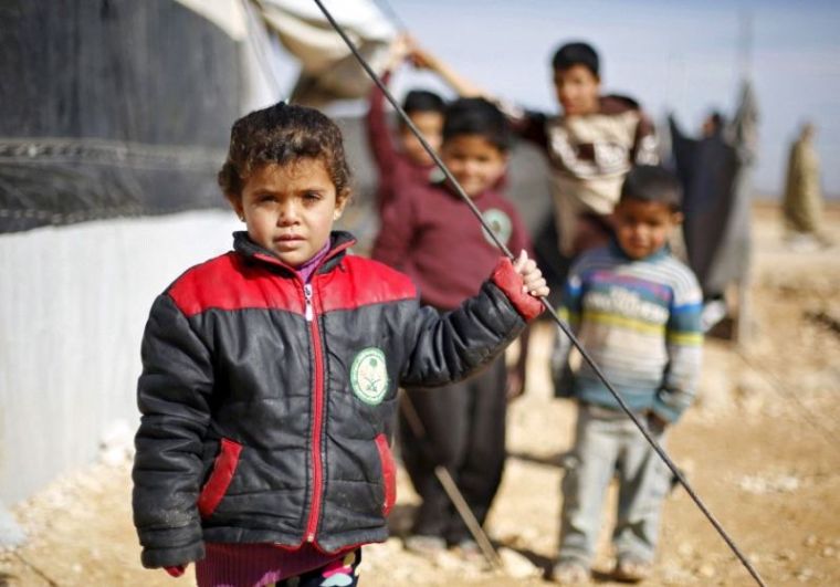 Syrian refugee children pose as they play near their families' residence at Al Zaatari refugee camp in the Jordanian city of Mafraq, near the border with Syria, January 30, 2016.