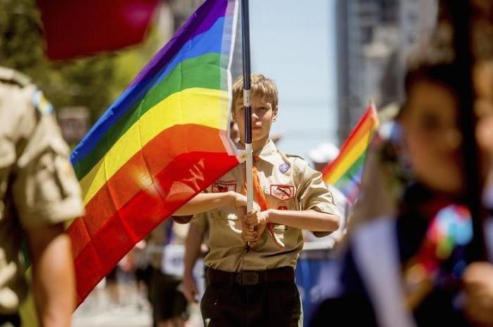 Boy Scout Casey Chambers carries a rainbow flag during the San Francisco Gay Pride Festival in California June 29, 2014.